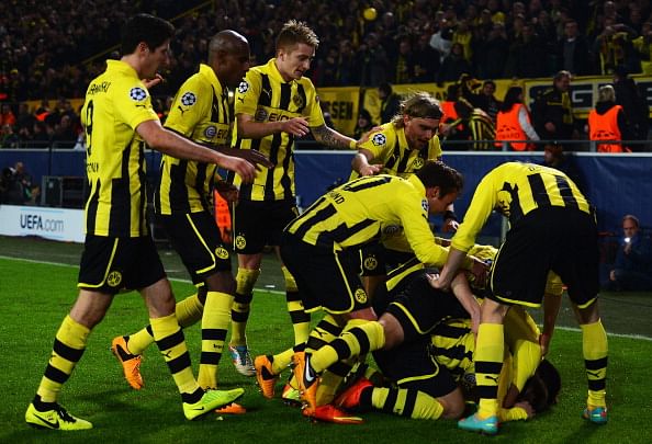 celebrates with team mates after scoring his teams third goal during the UEFA Champions League round of 16 second leg match between Borussia Dortmund and Shakhtar Donetsk at Signal Iduna Park on March 5, 2013 in Dortmund, Germany. (Photo by Lars Baron/Bongarts/Getty Images)